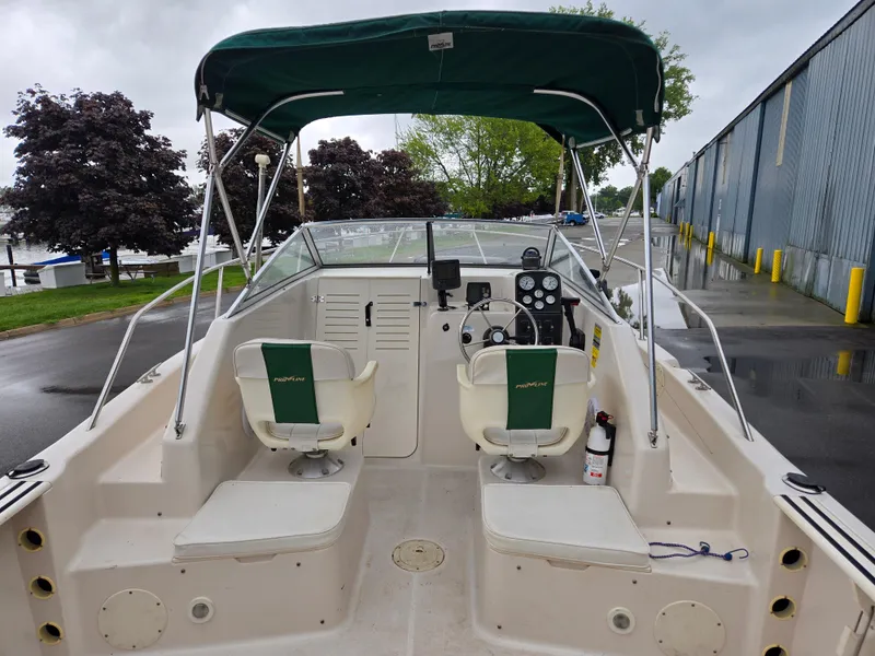 Slide: The Image of 1997 Pro-Line 201 Walkaround boat interior with green canopy and dual seats. - 25