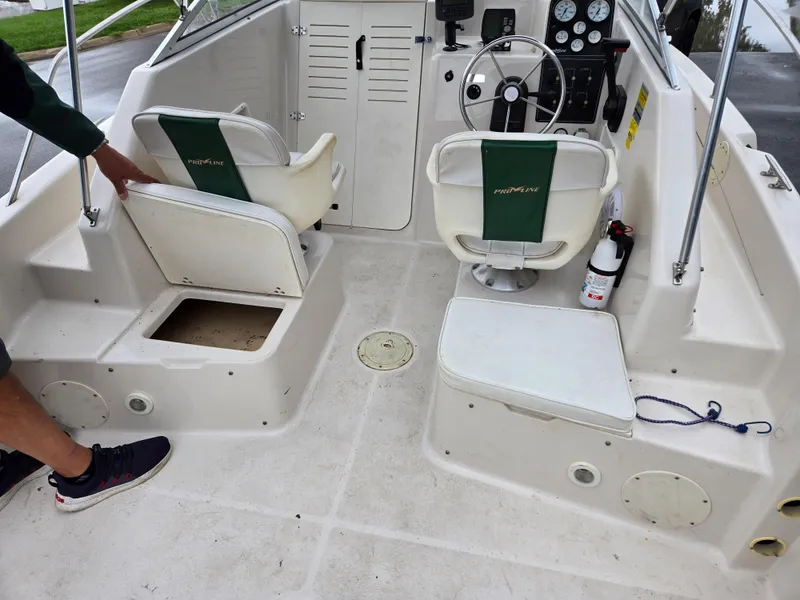 Slide: The Image of 1997 Pro-Line 201 Walkaround boat interior with seating and steering console. - 26