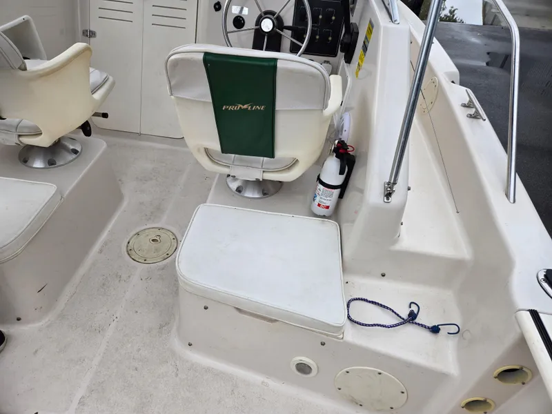 Slide: The Image of 1997 Pro-Line 201 Walkaround boat interior with seating and steering wheel. - 29