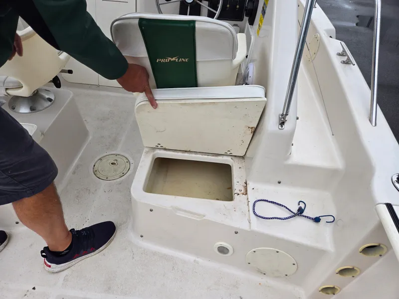 Slide: The Image of 1997 Pro-Line 201 Walkaround boat interior with storage compartment and seating. - 30