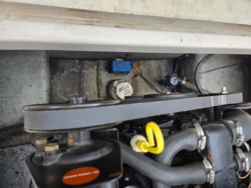 Slide: The Image of Engine compartment of a 1997 Pro-Line 201 Walkaround boat, showing belts and components. - 36