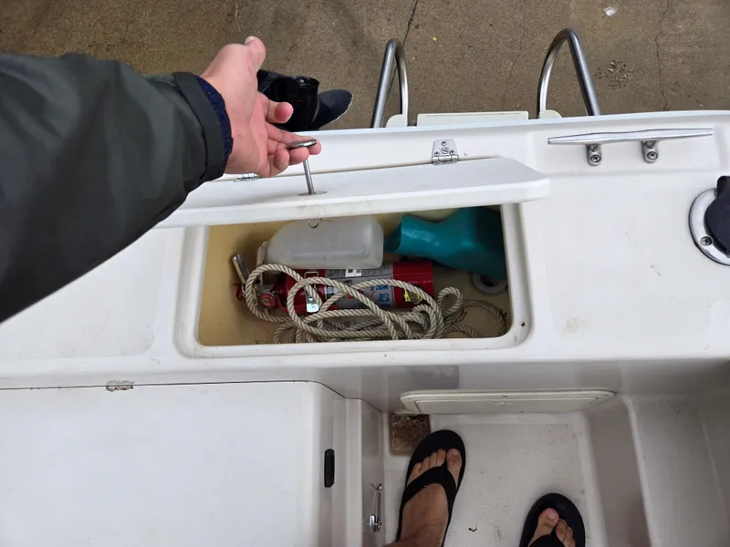 Slide: The Image of 1997 Pro-Line 201 Walkaround boat storage compartment with ropes and supplies. - 40