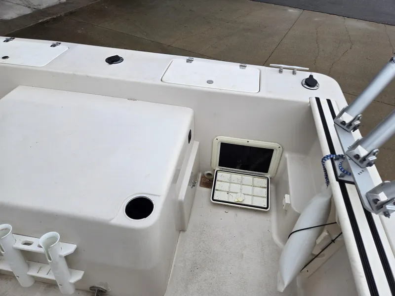 Slide: The Image of 1997 Pro-Line 201 Walkaround boat deck with storage compartments and rod holders. - 41