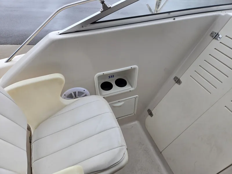 Slide: The Image of 1997 Pro-Line 201 Walkaround boat interior with white seating and cup holders. - 43