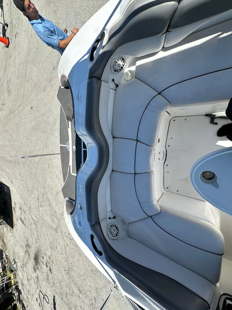 Slide: The Image of 2011 Yamaha Boats SX210 interior with gray seating and speaker, viewed from above. - 12