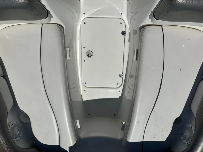 Slide: The Image of Interior view of a 2011 Yamaha SX210 boat, featuring seating and storage compartment. - 15