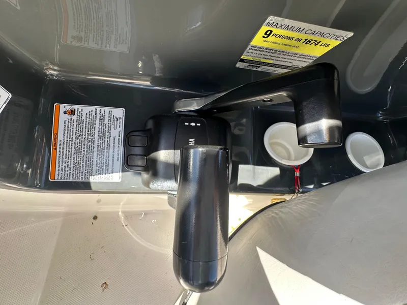 Slide: The Image of 2011 Yamaha SX210 boat throttle control with capacity warning labels. - 17