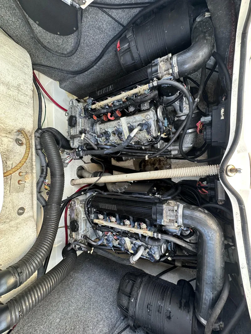 Slide: The Image of Engine compartment of a 2011 Yamaha Boats SX210, showcasing dual engines and components. - 21