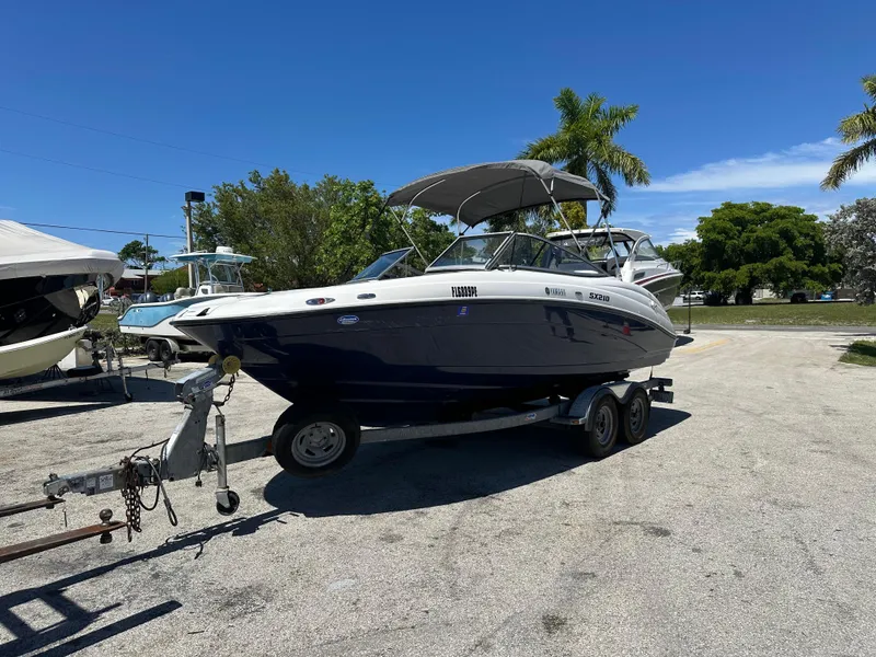 Slide: The Image of 2011 Yamaha SX210 boat on trailer, parked outdoors under clear blue sky. - 5