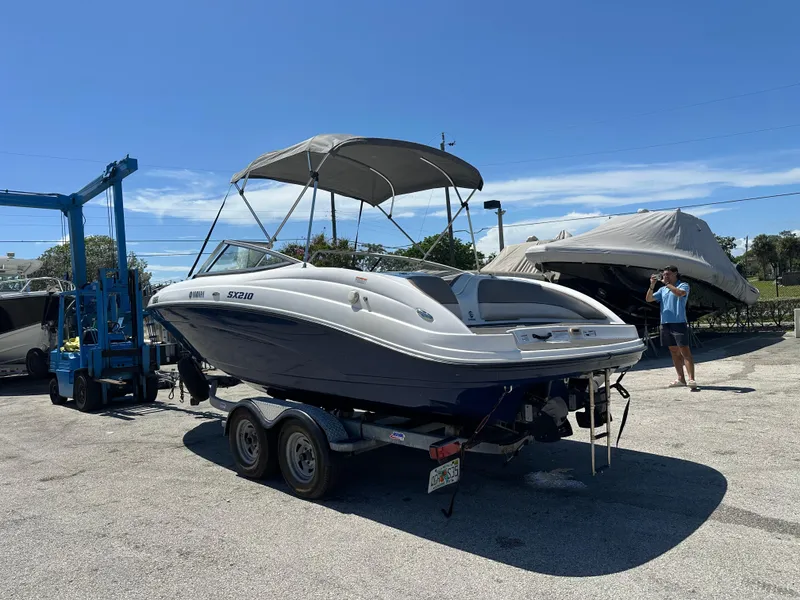 Slide: The Image of 2011 Yamaha SX210 boat on trailer under clear blue sky. - 6
