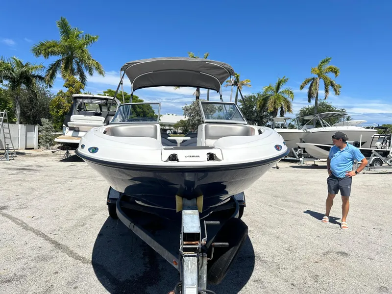 Slide: The Image of 2011 Yamaha SX210 boat on trailer, parked outdoors with palm trees in background. - 7