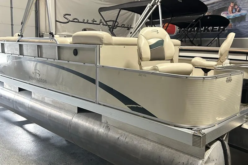Slide: The Image of 2005 Bennington II 227FSi pontoon boat with Johnson 50 outboard motor in a garage. - 2