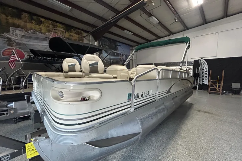Slide: The Image of 2005 Bennington II 227FSi pontoon boat interior with beige seating and carpeted floor. - 5