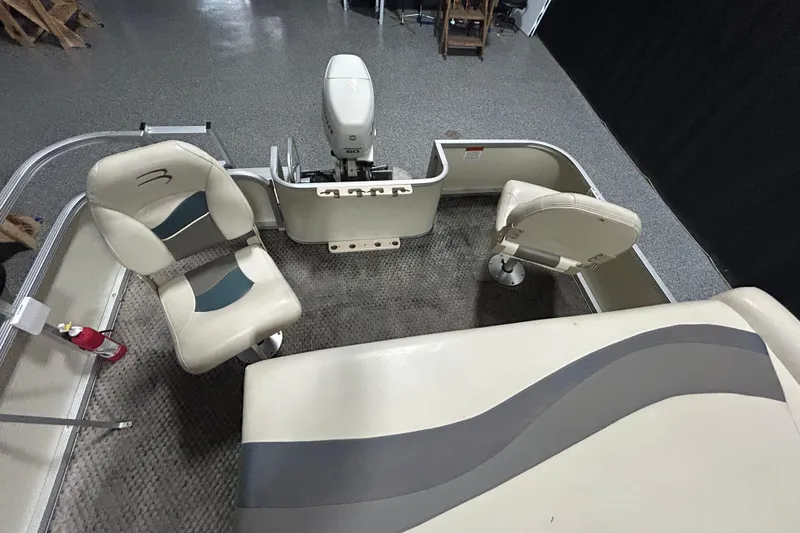 Slide: The Image of Interior of a 2005 Bennington II 227FSi pontoon boat with beige seating and helm. - 8