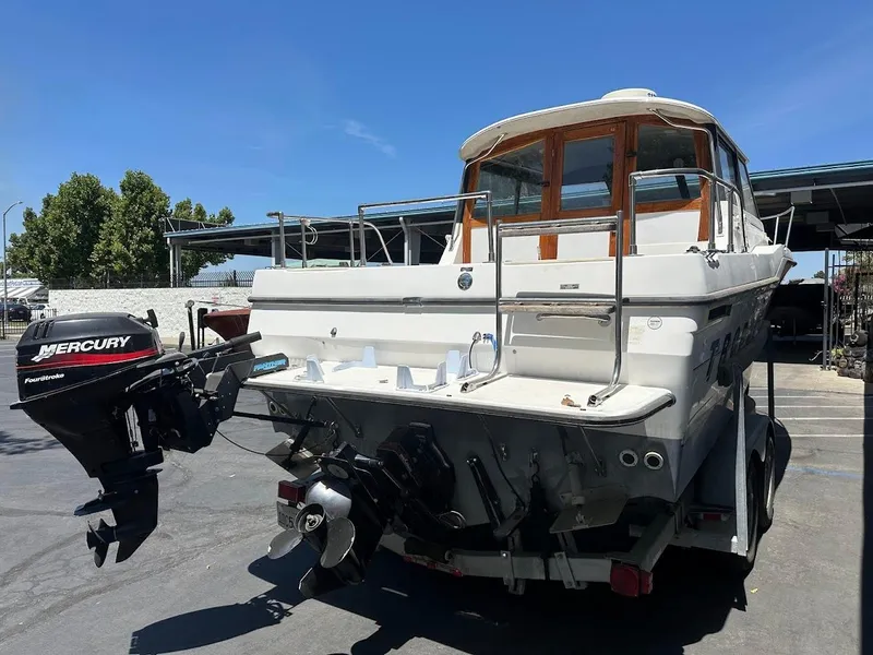 Slide: The Image of 1992 Bayliner 2359 Trophy boat with Mercury outboard motor on trailer. - 10
