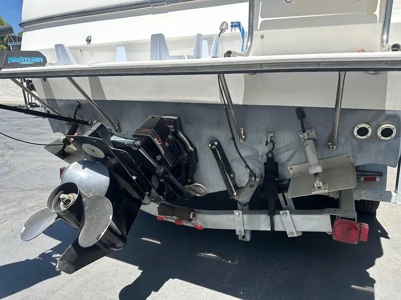 Slide: The Image of 1992 Bayliner 2359 Trophy boat stern with propeller and outboard motor. - 11