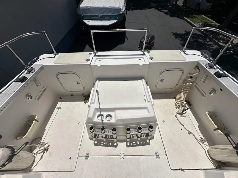 Slide: The Image of 1992 Bayliner 2359 Trophy boat deck with storage compartments and fishing rod holders. - 14