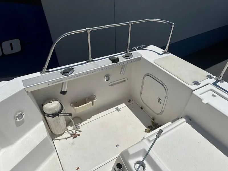 Slide: The Image of 1992 Bayliner 2359 Trophy boat deck with railing, storage hatch, and fishing rod holder. - 15