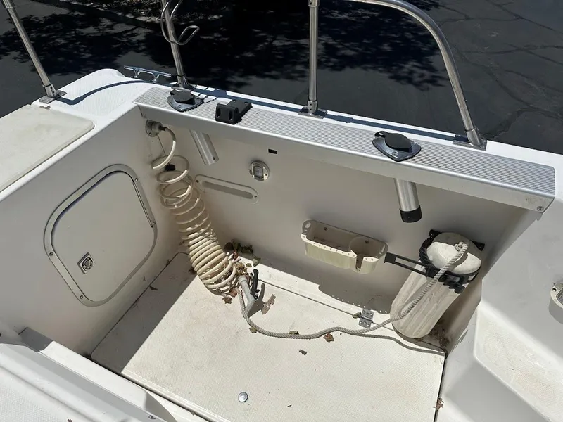 Slide: The Image of 1992 Bayliner 2359 Trophy boat deck with coiled hose and storage compartments. - 18