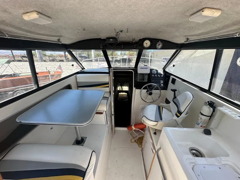 Slide: The Image of Interior of 1992 Bayliner 2359 Trophy boat with seating, table, and steering console. - 20
