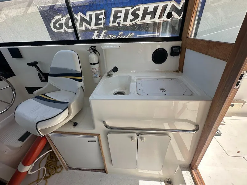 Slide: The Image of Interior of 1992 Bayliner 2359 Trophy boat with seating and sink area. - 23