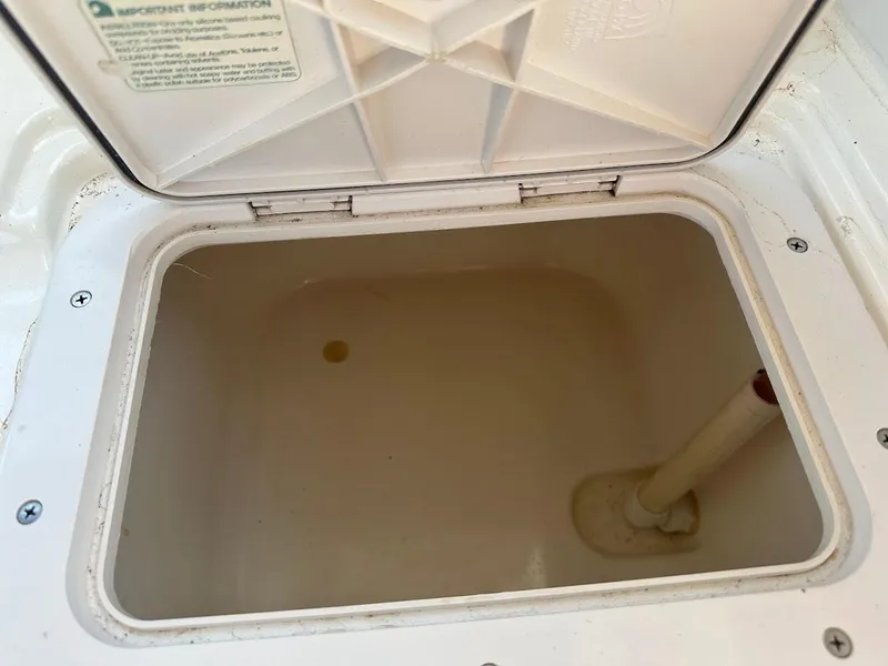 Slide: The Image of Open storage compartment on 1992 Bayliner 2359 Trophy boat, showing interior details. - 25