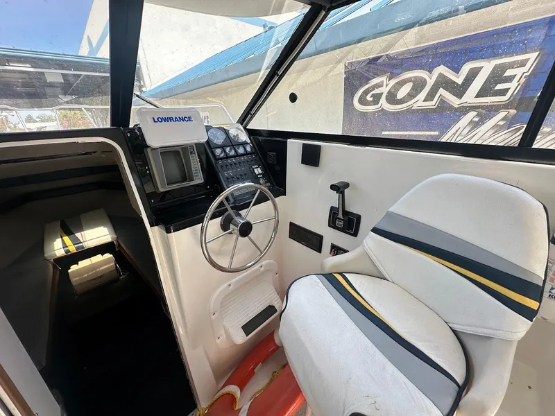 Slide: The Image of Interior of 1992 Bayliner 2359 Trophy boat with steering wheel and Lowrance navigation system. - 28