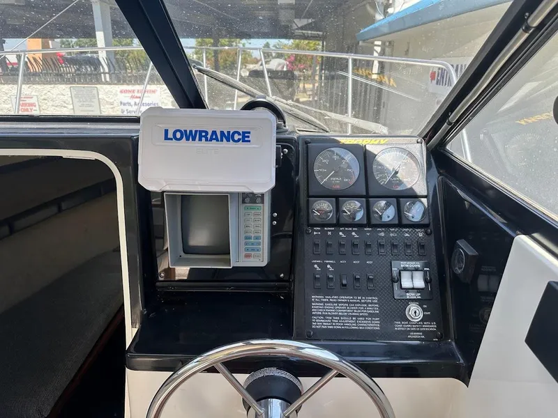 Slide: The Image of 1992 Bayliner 2359 Trophy boat dashboard with Lowrance GPS and control panel. - 29