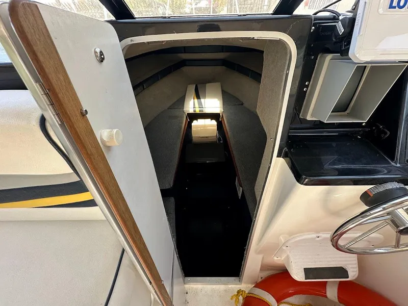Slide: The Image of 1992 Bayliner 2359 Trophy cabin interior with steering wheel and open door view. - 31