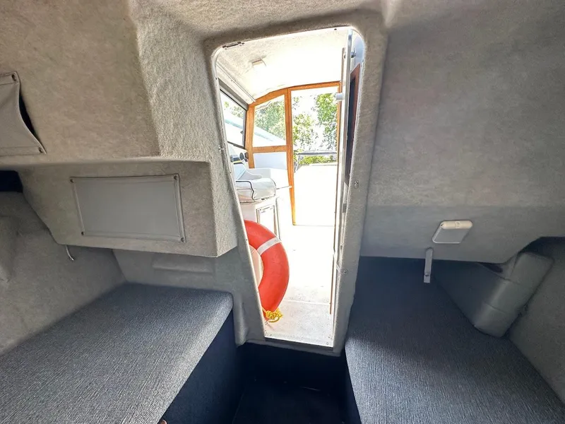 Slide: The Image of Interior cabin of 1992 Bayliner 2359 Trophy boat with seating and life preserver. - 37