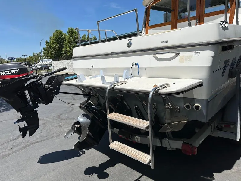 Slide: The Image of 1992 Bayliner 2359 Trophy boat with Mercury outboard motor, rear view showing propeller and swim platform. - 39