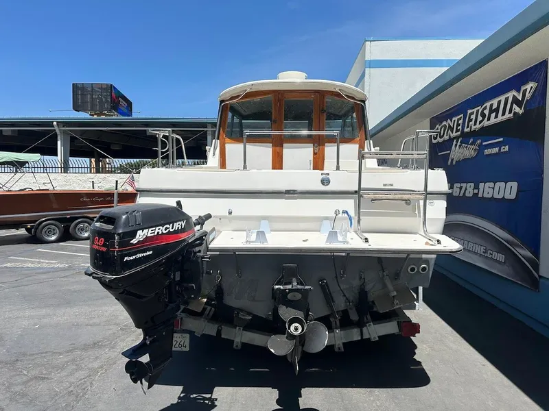 Slide: The Image of 1992 Bayliner 2359 Trophy boat with Mercury outboard motor, parked outdoors. - 9