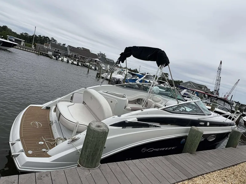 The Image of 2018 Crownline 264 CR boat docked at marina, featuring sleek design and spacious seating. - 1