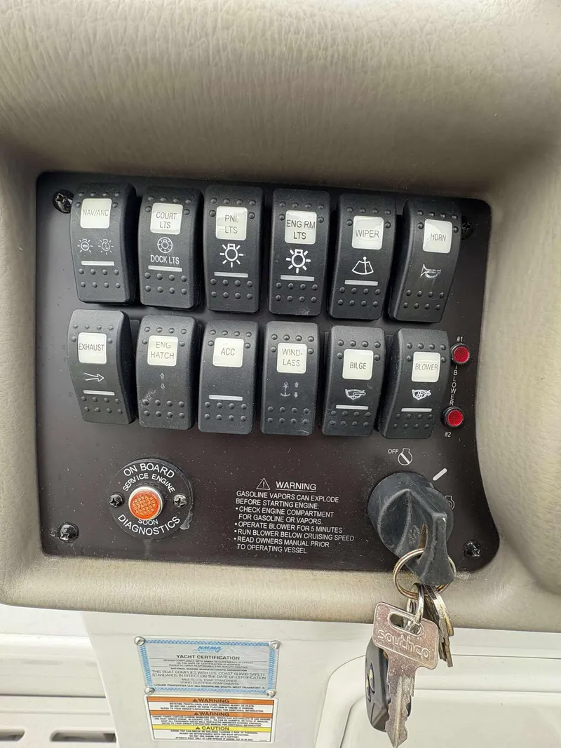 Slide: The Image of Control panel of a 2018 Crownline 264 CR boat with labeled switches and ignition keys. - 14