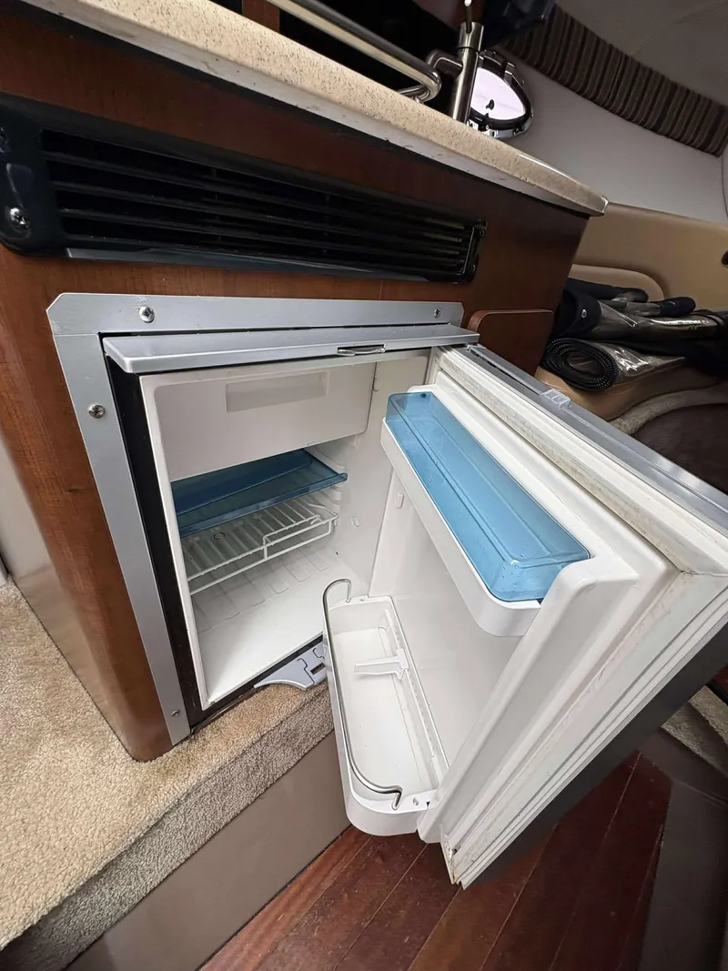 Slide: The Image of Open mini fridge inside 2018 Crownline 264 CR boat cabin. - 15