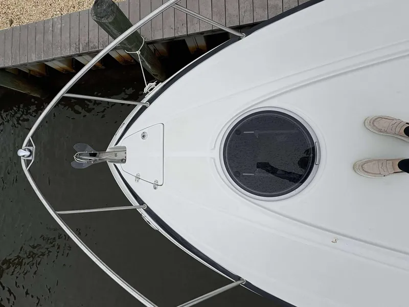 Slide: The Image of Bow view of 2018 Crownline 264 CR boat docked by wooden pier. - 26