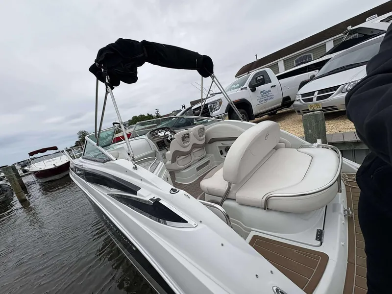 Slide: The Image of 2018 Crownline 264 CR boat docked, featuring sleek design and comfortable seating. - 3