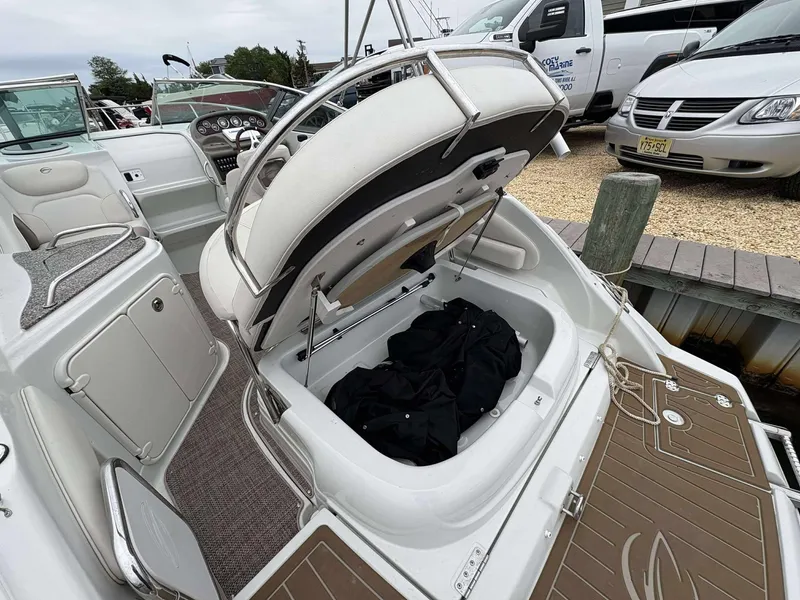 Slide: The Image of 2018 Crownline 264 CR boat interior with open storage compartment. - 6