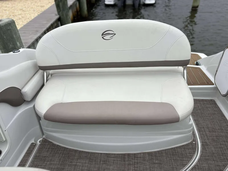 Slide: The Image of 2018 Crownline 264 CR boat seating area with white and beige upholstery. - 8