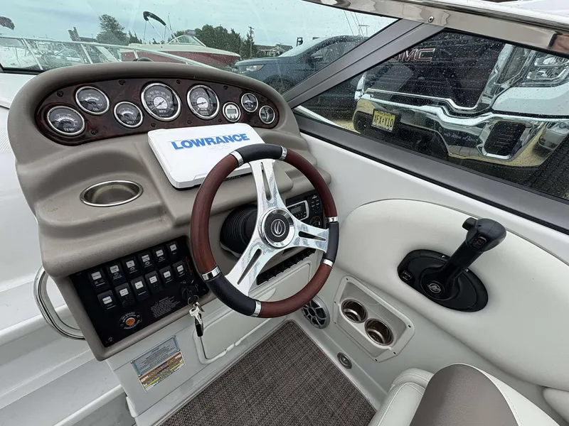 Slide: The Image of 2018 Crownline 264 CR boat dashboard with steering wheel and control panel. - 9