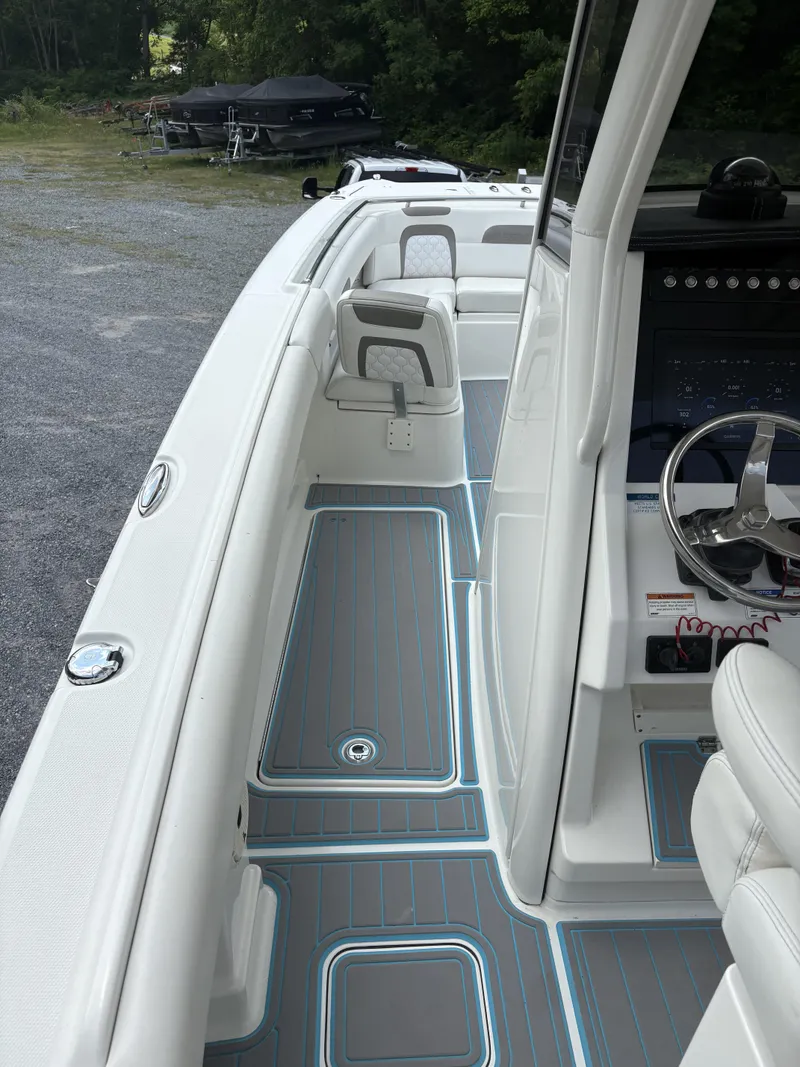 Slide: The Image of 2020 World Cat 280 CC-X boat interior with sleek design and modern dashboard. - 12