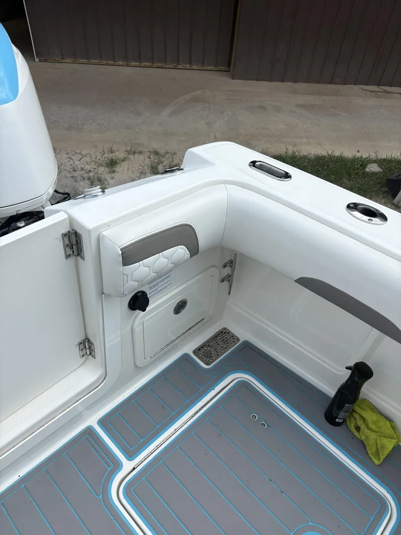 Slide: The Image of 2020 World Cat 280 CC-X boat interior with storage compartment and non-slip flooring. - 14