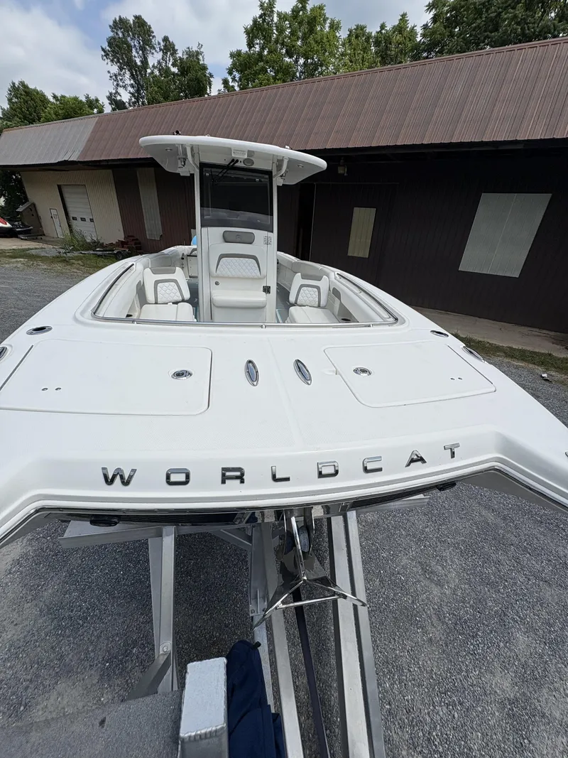 Slide: The Image of 2020 World Cat 280 CC-X boat on trailer, parked near a building. - 2