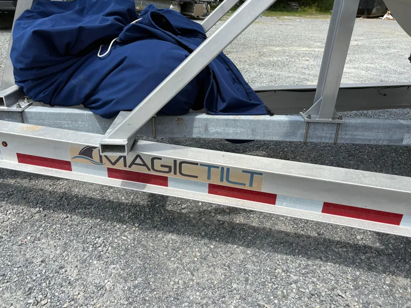 Slide: The Image of Trailer with "Magic Tilt" logo, holding a covered 2020 World Cat 280 CC-X boat. - 22