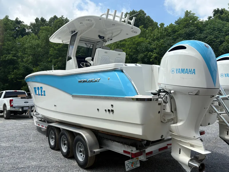 Slide: The Image of 2020 World Cat 280 CC-X boat with Yamaha engines on a trailer, surrounded by trees. - 3