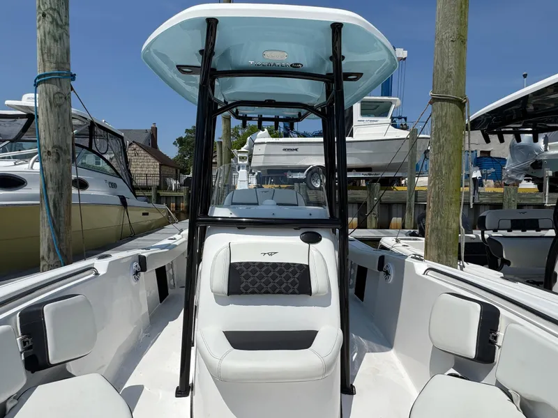 Slide: The Image of 2022 Tidewater 220 LXF boat with T-top, docked in marina. - 10