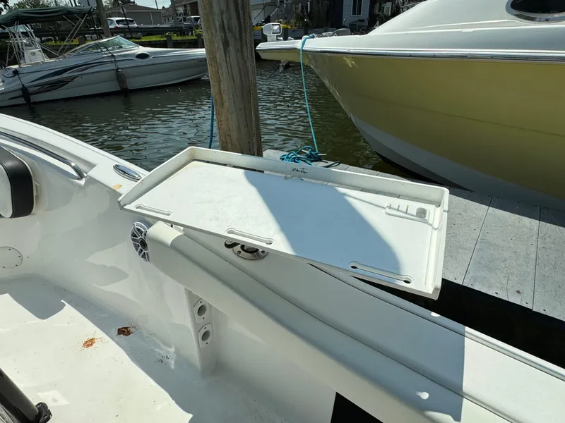 Slide: The Image of 2022 Tidewater 220 LXF boat with a foldable cutting board on deck. - 19