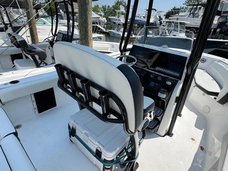 Slide: The Image of 2022 Tidewater 220 LXF boat interior with helm, seating, and fishing rod holders. - 3