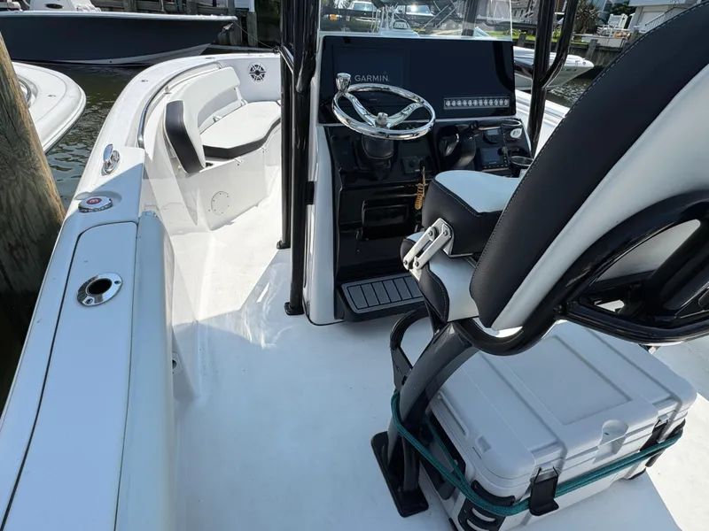 Slide: The Image of 2022 Tidewater 220 LXF boat interior with steering console and seating. - 5