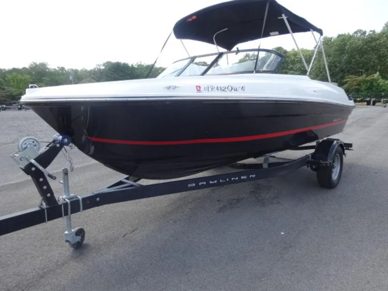 Slide: The Image of 2022 Bayliner VR4 boat on trailer, black hull with red stripe, parked outdoors. - 10